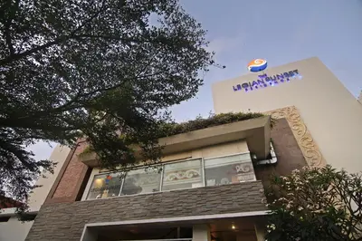 a building with a sign on the top of it at The Legian Sunset Residence in Seminyak