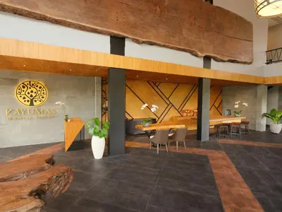 a lobby of a restaurant with tables and chairs at Kayumas Seminyak Resort in Seminyak