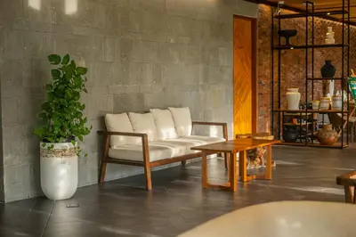 a living room with a couch and a table at Kayumas Seminyak Resort in Seminyak