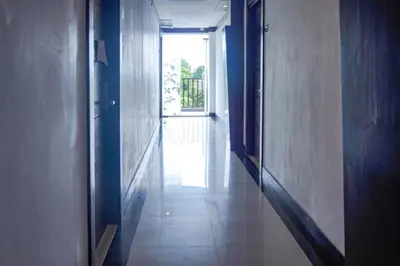 an empty hallway with a door and a window at KoolKost at Bypass Jimbaran - Minimum Stay 30 Nights in Kuta