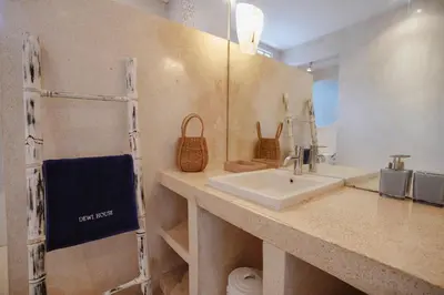 a bathroom with a sink and a mirror at Villa Dewi in Seminyak