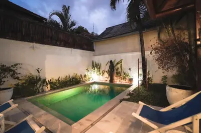 a swimming pool in the backyard of a house at Villa Dewi in Seminyak