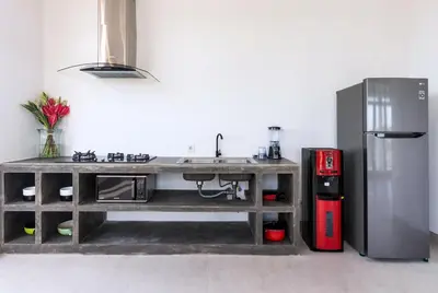 a kitchen with a sink and a refrigerator at Villa Besakih in Canggu