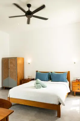 a bedroom with a bed with a ceiling fan at Villa Sakayana 4BR Canggu in Canggu