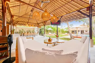 an outdoor patio with white chairs and tables at Villa Toscana - 7 BDR Luxury Villa with private pool in Seminyak