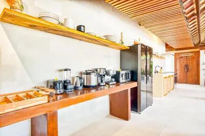 a kitchen with a counter with pots and pans at Villa Toscana - 7 BDR Luxury Villa with private pool in Seminyak