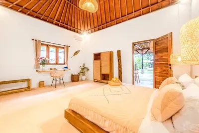 a bedroom with a large bed and a table at Villa Toscana - 7 BDR Luxury Villa with private pool in Seminyak