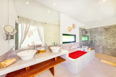 a bathroom with two sinks and a tub with a red rug at Villa Toscana - 7 BDR Luxury Villa with private pool in Seminyak