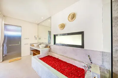 a bathroom with a large tub filled with red flowers at Villa Toscana - 7 BDR Luxury Villa with private pool in Seminyak
