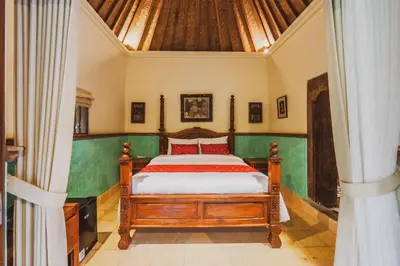 a bedroom with a bed in a room at Bebek Cottages Sanur in Sanur