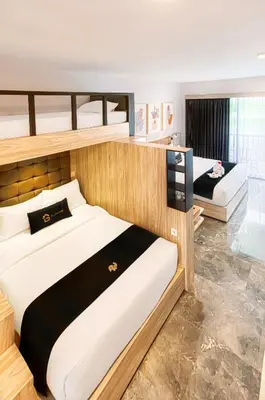 a bedroom with two bunk beds in it at Graha Socio Hotel Nusa Dua Bali in Nusa Dua