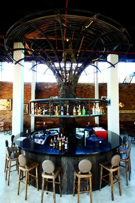 a bar in a building with chairs around it at Sun Island Hotel & Spa Legian in Legian