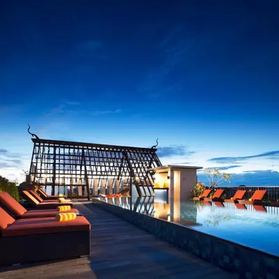 a villa with a swimming pool at night at Sun Island Hotel & Spa Legian in Legian