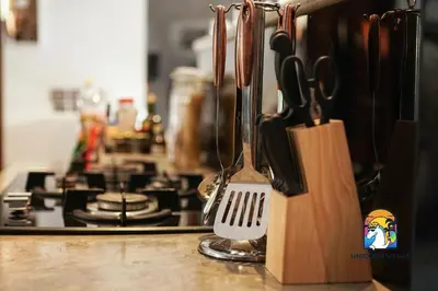 a kitchen counter with a spatula and utensils on a stove at Villa di Sawah - by Unicorn Villas Bali in Kerobokan