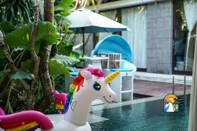 a toy unicorn in the water near a pool at Villa di Sawah - by Unicorn Villas Bali in Kerobokan