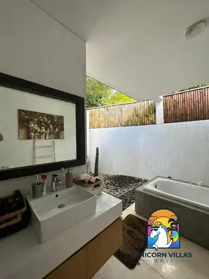 a bathroom with a sink and a bath tub at Villa di Sawah - by Unicorn Villas Bali in Kerobokan