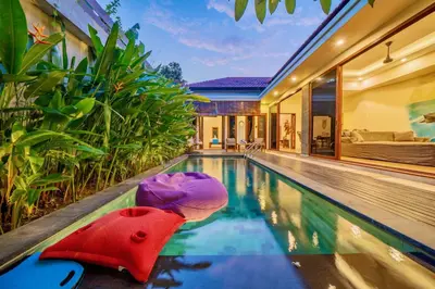 a red toy boat in a swimming pool in a house at Villa Paradise Seminyak in Seminyak