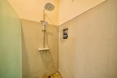 a shower with a shower head in a bathroom at Villa Paradise Seminyak in Seminyak