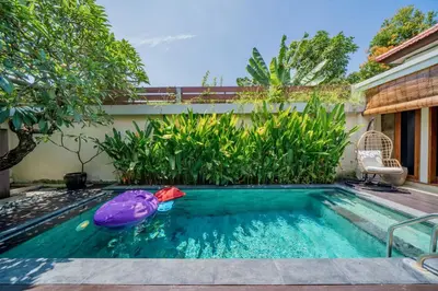 a swimming pool with an inflatable pool toy at Villa Paradise Seminyak in Seminyak