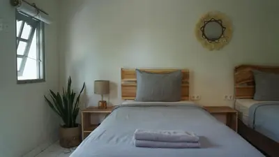 a bedroom with a bed with a towel on it at Endless Summer Surf Camp Kuta in Kuta