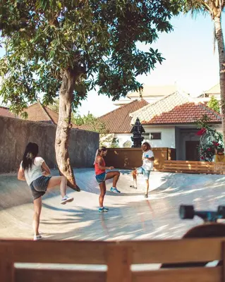 a group of people playing in a pool at Endless Summer Surf Camp Kuta in Kuta