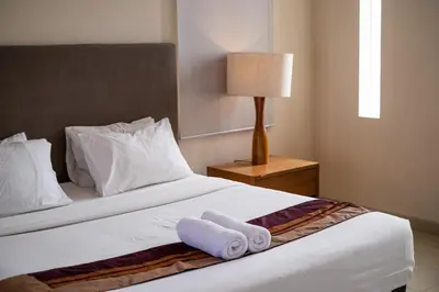 a hotel room with a bed with towels on it at Villa Kinawa Seminyak in Seminyak