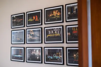 a bunch of pictures hanging on a wall at Villa Kinawa Seminyak in Seminyak