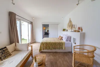 a white bedroom with a bed and a couch at Villa M2 Seminyak by Alfred in Bali in Seminyak