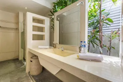 a bathroom with a sink and a large mirror at VILLA Nuri Merah 2 in Seminyak