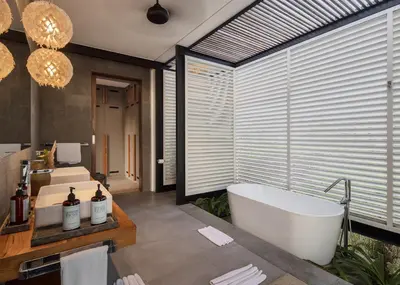 a bathroom with two sinks and a bath tub at La Maison d'Ulysse - Luxury 4-Bedroom Villa with Pool in Canggu in Kerobokan