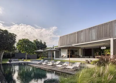 a house with a swimming pool next to a building at La Maison d'Ulysse - Luxury 4-Bedroom Villa with Pool in Canggu in Kerobokan