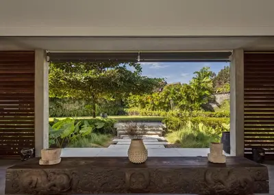 a vase sitting on a table in front of a window at La Maison d'Ulysse - Luxury 4-Bedroom Villa with Pool in Canggu in Kerobokan