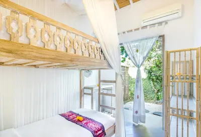 a bedroom with two bunk beds and a window at Villa 007 in Seminyak