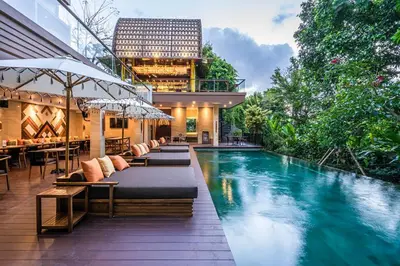 a hotel with a swimming pool and a restaurant at Pandawa All Suites Hotel in Seminyak