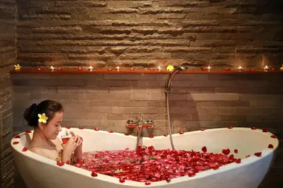 a young girl sitting in a bathtub full of cherries at Pandawa All Suites Hotel in Seminyak