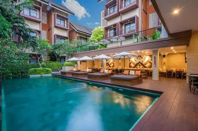 a swimming pool in front of a building at Pandawa All Suites Hotel in Seminyak