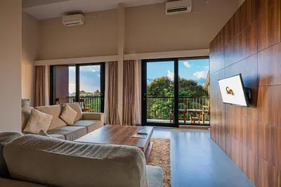 a living room with a couch and a table at Pandawa All Suites Hotel in Seminyak