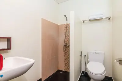 a bathroom with a toilet and a sink at Mi Casa Residence in Seminyak