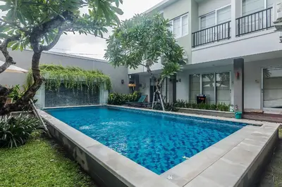 a swimming pool in front of a building at Mi Casa Residence in Seminyak