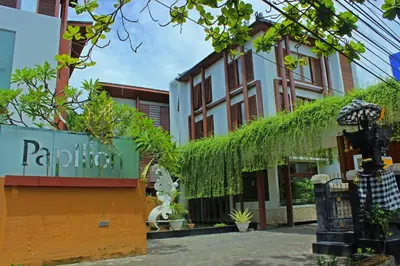 a building with ivy on the side of it at Papillon Umalas Villas in Canggu