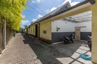 a motorcycle parked on a sidewalk next to a building at Villa Jalak in Seminyak
