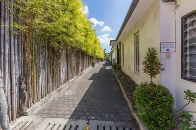 an alley between two buildings with a fence at Villa Jalak in Seminyak
