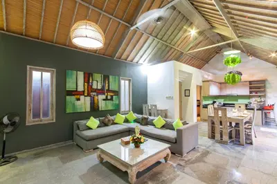 a living room with a couch and a table at Villa Jalak in Seminyak