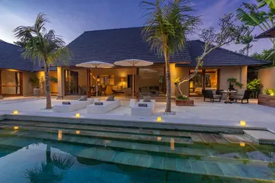 a villa with a swimming pool and a house at Balidroomvilla Sanur - Full Serviced - Beachside in Sanur