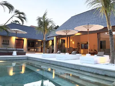 a villa with a swimming pool and a resort at Balidroomvilla Sanur - Full Serviced - Beachside in Sanur