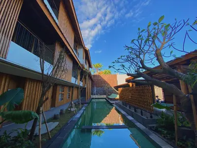 a pool in the courtyard of a building at Tekuni 2 in Legian