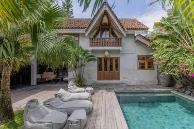 a house with a swimming pool in front of a house at Villa Palm Jari 1 by Alfred in Bali in Canggu