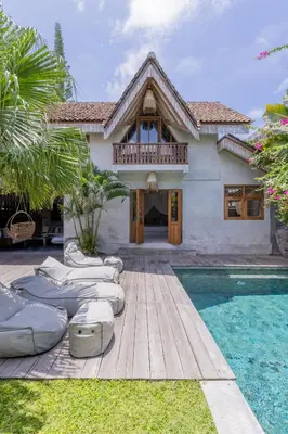 a villa with a swimming pool and a house at Villa Palm Jari 1 by Alfred in Bali in Canggu