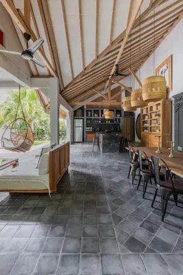 an open living room with a table and chairs at Villa Palm Jari 1 by Alfred in Bali in Canggu