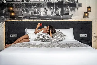 a woman laying on top of a bed at Villa Australis in Kerobokan